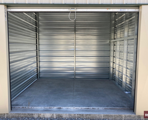 mini storage unit interior with new steel walls and a concrete floor