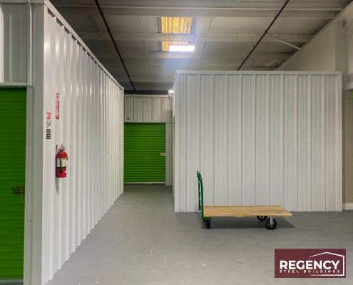 indoor storage units with green doors and white wall panels