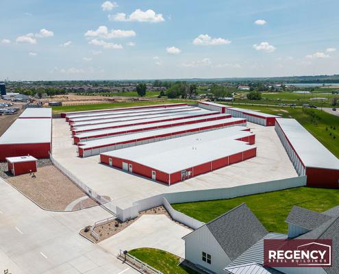 image of mini storage buildings with red walls and white roofs