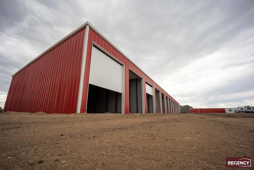 image of mini storage buildings with red walls and white roofs underconstruction