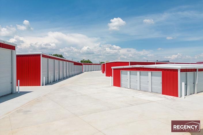 image of mini storage buildings with red walls and white roofs