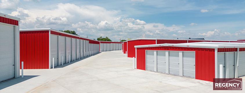 image of mini storage buildings with red walls and white roofs