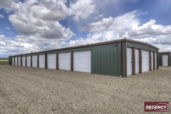 photo of grey and maroon, brand new mini storage facility, grey building with brown trim and white doors