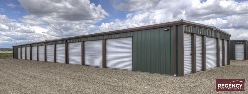 photo of grey and maroon, brand new mini storage facility, grey building with brown trim and white doors
