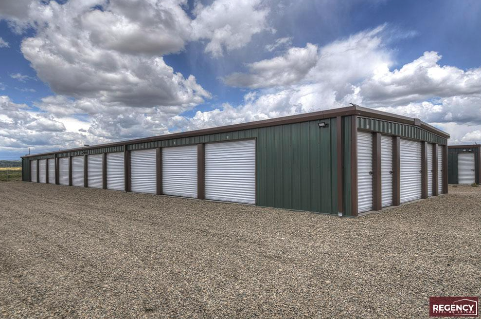 photo of grey and maroon, brand new mini storage facility, grey building with red trim and white doors