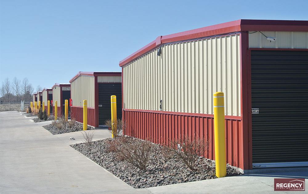 a Self Storage Complex with red trim and broen doors with landscaping