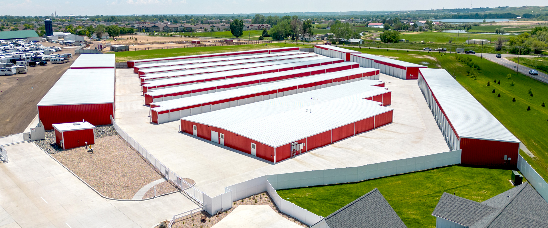 Ac Regency Steel buildings mini-storage building kit facility in Windsor, CO. 13 Red mini storage buildings with a white roof for personal storage, RV storage and climate controlled.