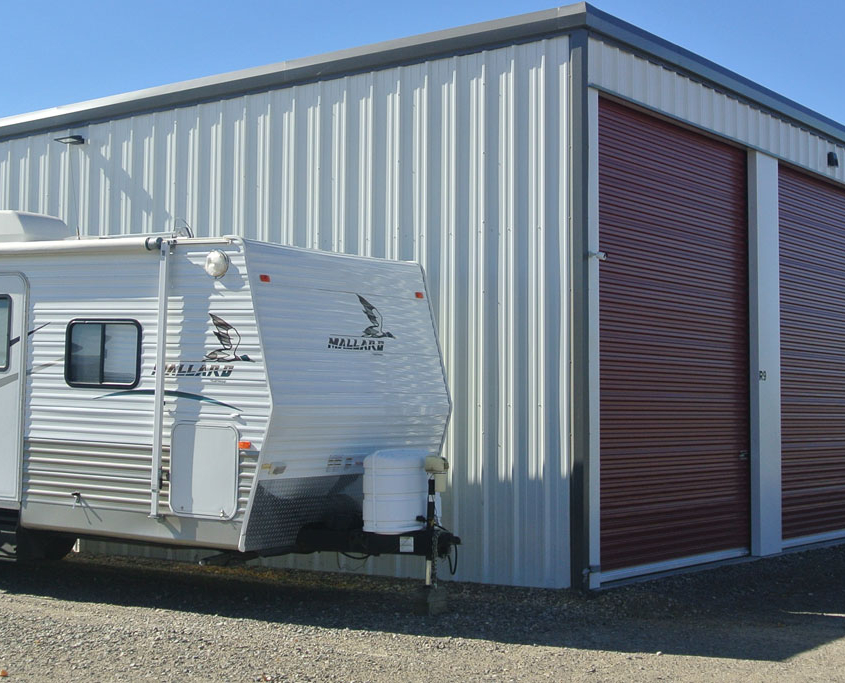 rv trailer next to a new mini storage building